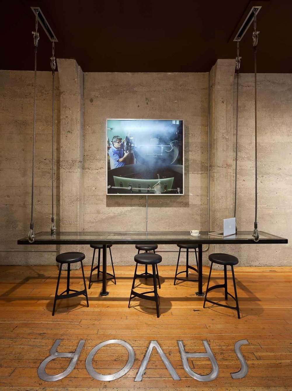 Espresso Lounge — High table and stools between concrete columns