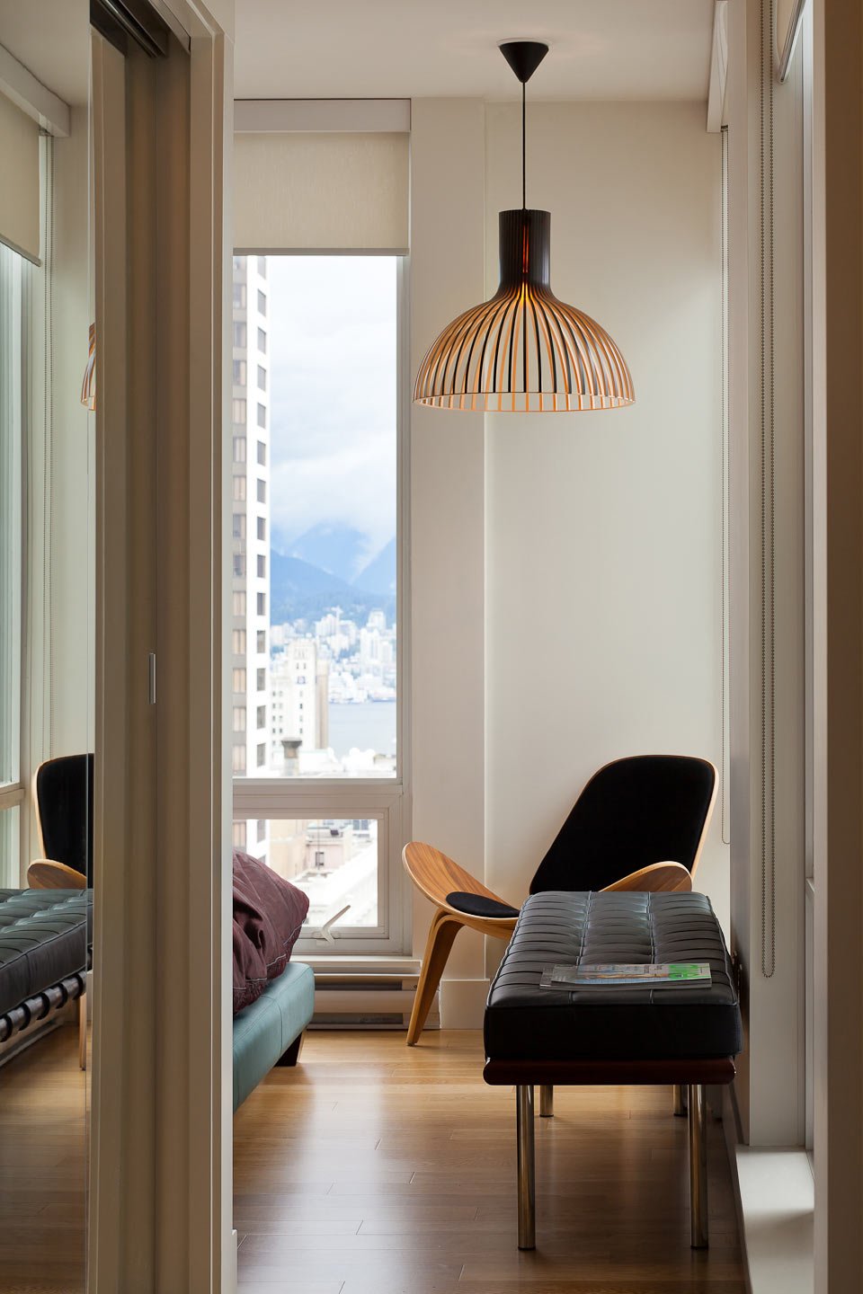 City Retreat — View through a doorway to a chair and woven pendant