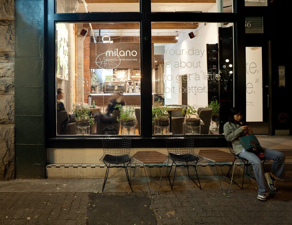 Espresso Lounge — Street view of the illuminated café and outdoor seating