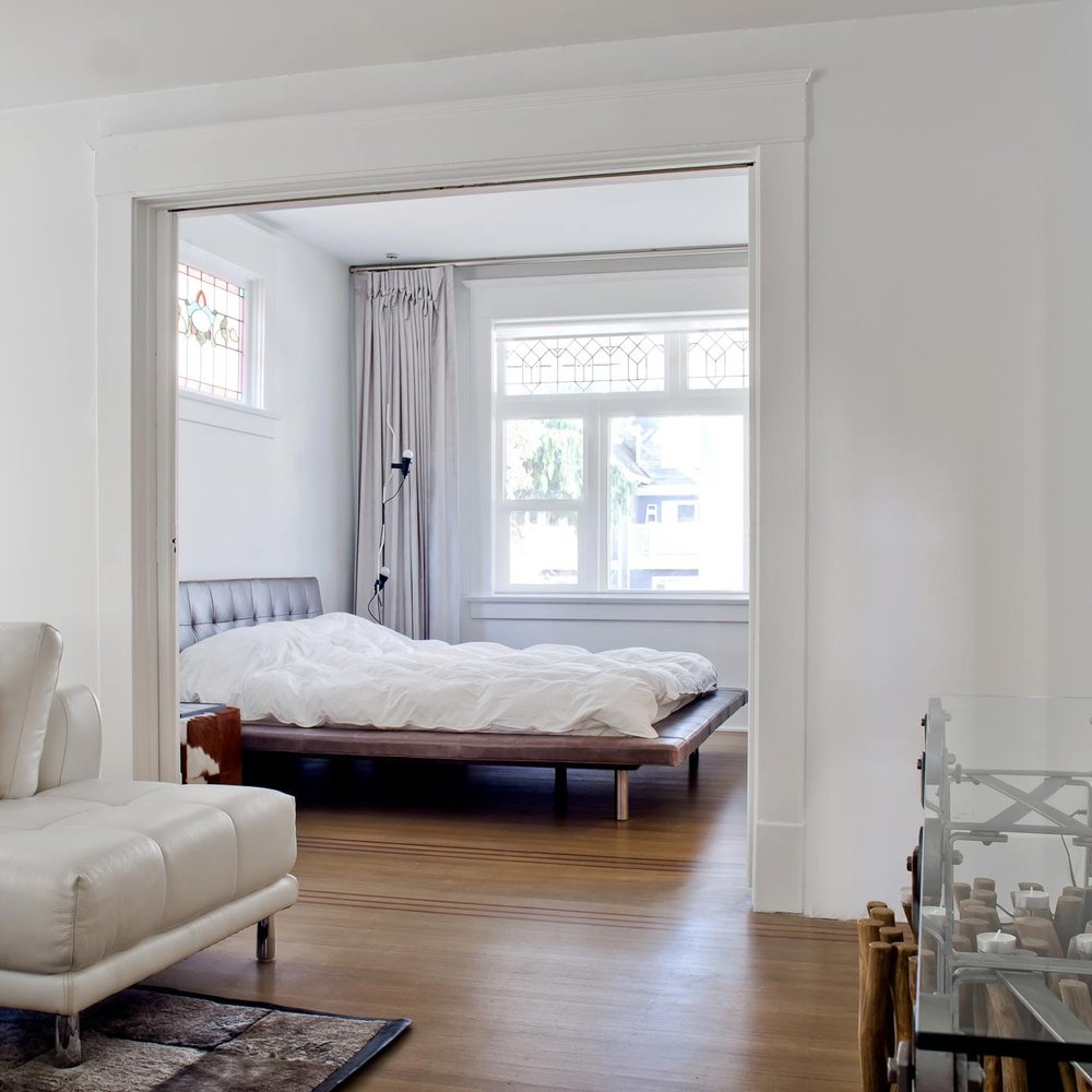 Kitsilano House — Bedroom viewed through an open doorway