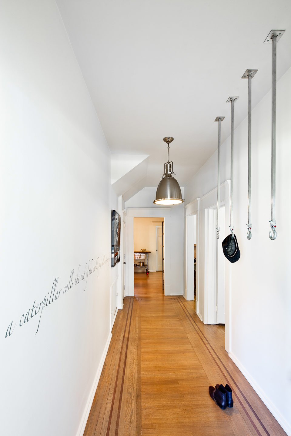 Kitsilano House — Long hallway linking rooms through a white interior