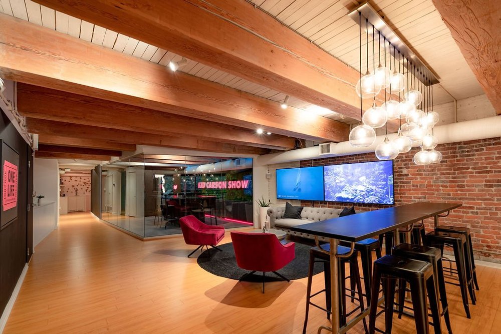 Podcast Studio — Recording lounge with exposed timber beams, brickwork and a high table